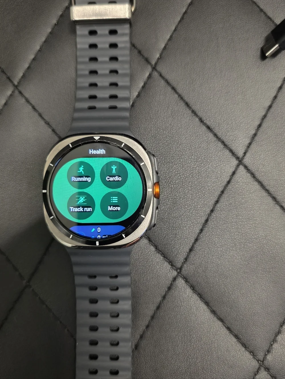 Samsung Gray Smartwatch with Orange Accent and Dark Gray Band